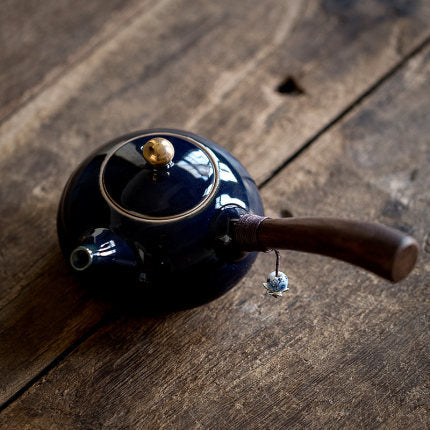 Ceramic teapot with wooden handle