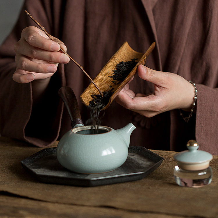 Ceramic teapot with wooden handle